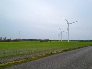 Vindmøller i Troldhede på en mark og asfaltvej, Landinspektør Vest referenceprojekt